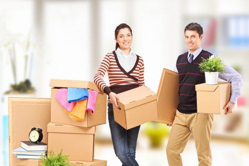 Commercial movers handling desks and IT equipment during an office move